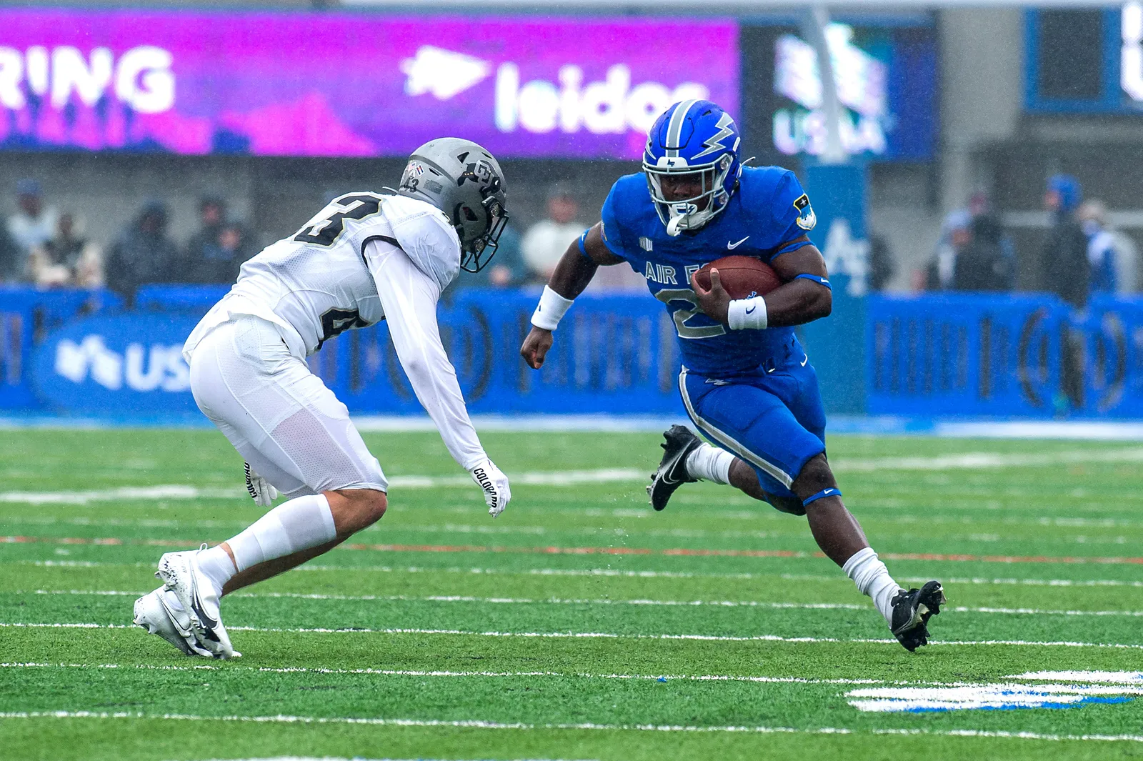 Colorado Buffaloes football players in black and gold uniforms in game action from the team's September 2022 matchup against Air Force.